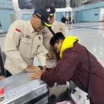 Jumardi saat mengecek bagasi jemaah di jalur fast track bandara Madinah. Foto: MCH 2026.