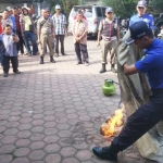 Simulasi cara memadamkan api oleh tim kebakaran Satpol PP Trenggalek di halaman kantor Kelurahan Sumbergedong.