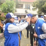 Pj Wali Kota Kediri saat mengenakan topi secara simbolis kepada salah satu mahasiswa. Foto: Ist