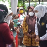 Gubernur Khofifah didampingi Wabup Aminatun Habibah saat berbincang dengan ibu-ibu dalam operasi minyak goreng murah. foto: SYUHUD/ BANGSAONLINE