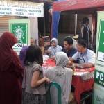BAKSOS LKNU: Kegiatan pengobatan gratis yang digelar PC LKNU Sidoarjo di Desa Sawotratap Kecamatan Gedangan, belum lama ini. foto istimewa
