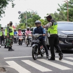 Petugas saat menghentikan pengguna jalan yang tidak memakai masker atau memakai masker tapi salah. foto: ist.