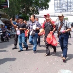 Aksi puluhan warga yang menggelar tabur bunga di lokasi amblesnya Jalan Sultan Agung, Jember.
