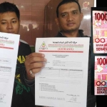 Dua orang jamaah menunjukkan blanko registrasi Aksi Bela Islam Jilid III, dan uang pecahan Rp 100 ribu yang diduga terdapat simbol 