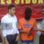 Tersangka Mazuar Anas alias Juan alias Travis (dua dari kanan) menunjukan barang bukti palu kepada petugas. (Nanang Ichwan/BANGSAONLINE)