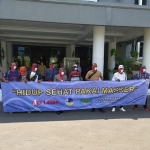 Dengan memakai masker merah putih, Wali Kota Risma foto bersama para awak media yang tergabung ke dalam Pokja Wartawan Pemkot Surabaya. (foto: YUDI A/ BANGSAONLINE).