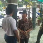 Tersangka kasus korupsi Jembatan Brawijaya Kota Kediri, Kasenan (baju batik) saat tiba di kantor Kejaksaan Negeri Kota Kediri. foto: ARIF K/ BANGSAONLINE