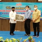 Ketua PWI Jatim Ainur Rohim didampingi Ketua PWI Lamongan, Bachtiar Febrianto menyerahkan penghargaan kepada Bupati Fadeli.