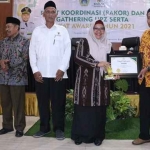Wabup Gresik Aminatun Habibah memberikan penghargaan kepada UPZ. Foto: SYUHUD/ BANGSAONLINE
