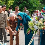 Pj Bupati Nganjuk bersama Pj Ketua TP PKK Nganjuk saat pemotongan pita.