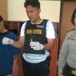 Kanit menunjukan BB sabu, di samping tersangka didampingi Polwan yang menyamar dalam penangkapan. foto: rusmiyanto/BANGSAONLINE