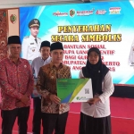 Bupati Mojokerto saat menyalurkan bantuan untuk guru TPQ secara simbolis.
