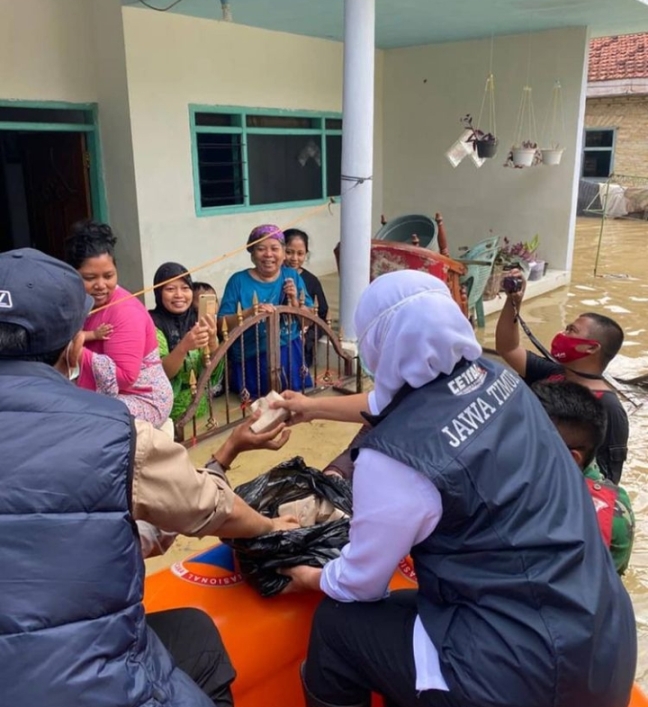 Gubernur Jawa Timur Khofifah Indar Parawansa membagikan nasi bungkus pada korban banjir di kawasan Patemon Jung Cang-cang Pamekasan Madura, Sabtu (19/12/2020).  foto: instagram/ khofifah.ip