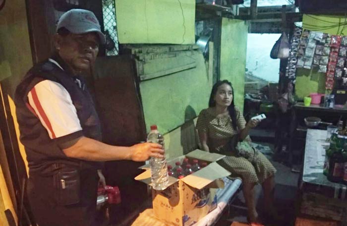 Petugas menunjukkan miras yang disimpan dalam kardus.
