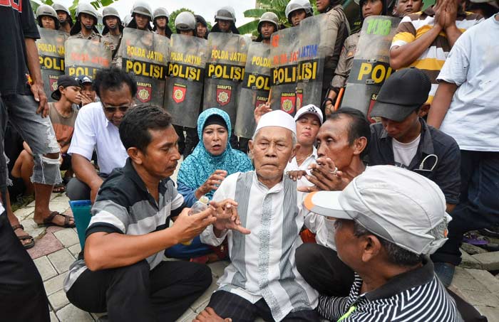 Salah satu warga penghuni yang terduduk lemas mengetahui rumahnya dibongkar.