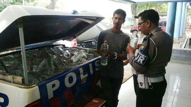 Petugas memeriksa ratusan botol cukrik yang sudah diamankan. (Irwan/BangsaOnline)
