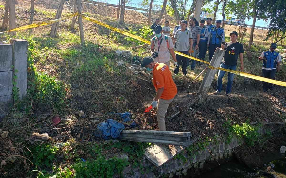 Petugas saat mengevakuasi tengkorak manusia di Jalan Tol Surabaya-Gempol KM 743.