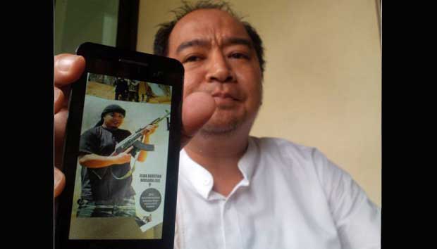Dody Riyanto, Ketua KNPI Depok, Jawa Barat, menunjukan foto mantan Ketua KNPI Depok periode 2000-2013, Agustian Hermawan yang tewas di Suriah. TEMPO/ Imam Hamdi