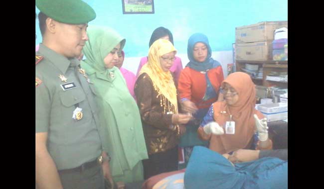 Salah satu warga saat menjalani pemasangan KB Implan disaksikan Dandim 0833 Kota Malang Letkol. Arm Aprianko Suseno,S.Sos beserta istri. foto: iwan irawan/ BANGSAONLINE