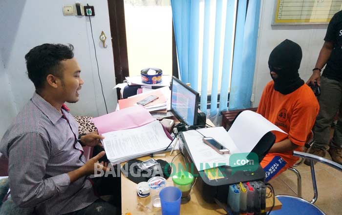 Oknum guru swasta pelaku pencabulan saat di ruang pemeriksaan Unit PPA Satreskrim Polres Jombang, Selasa (22/11). foto: RONY S/ BANGSAONLINE