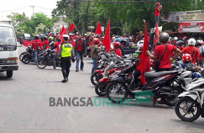 Ratusan buruh ketika demo di tengah jalan Tri Dharma Kebomas. foto: SYUHUD/ BANGSAONLINE