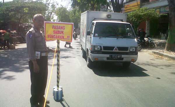 PERSIAPAN. Rambu-rambu lalu lintas baru dipasang di depan pasar tumpah Kecamatan Baureno. Rambu itu untuk meminimalisir adanya kemacetan saat arus mudik mendatang. Foto: eky nurhadi/BANGSAONLINE