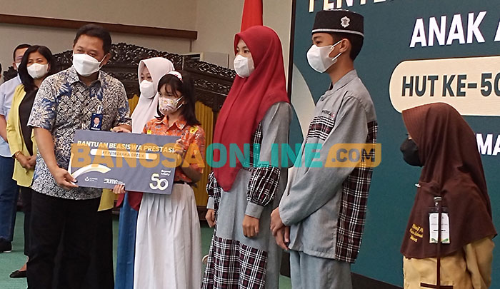 Direktur Keuangan dan Umum PT Petrokimia Gresik, Budi Wahju Soesilo, saat memberikan beasiswa kepada siswa. Foto: SYUHUD/BANGSAONLINE
