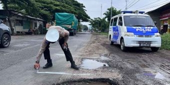 Polisi Kawal Pengaspalan Jalan Rusak di Pantura Situbondo