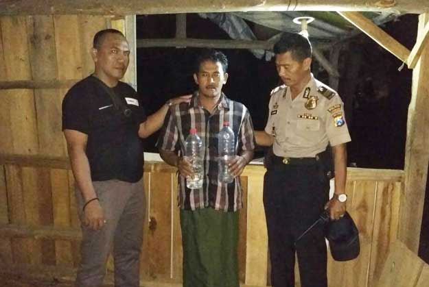 Kapolsek Wonosalam, AKP Suparno (kanan) sesaat setelah mengamankan penjual miras. foto: ROMZA/ BANGSAONLINE