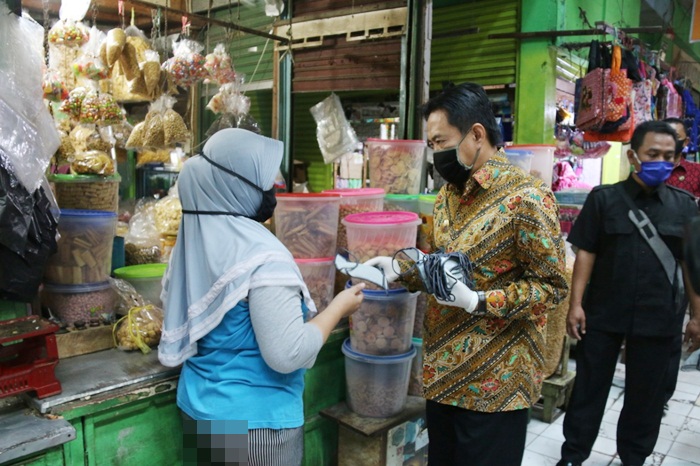 BAGI MASKER: Wabup Nur Ahmad membagikan masker sekaligus sosialisasi PSBB, di Pasar Krian, Selasa (21/4). foto: ist