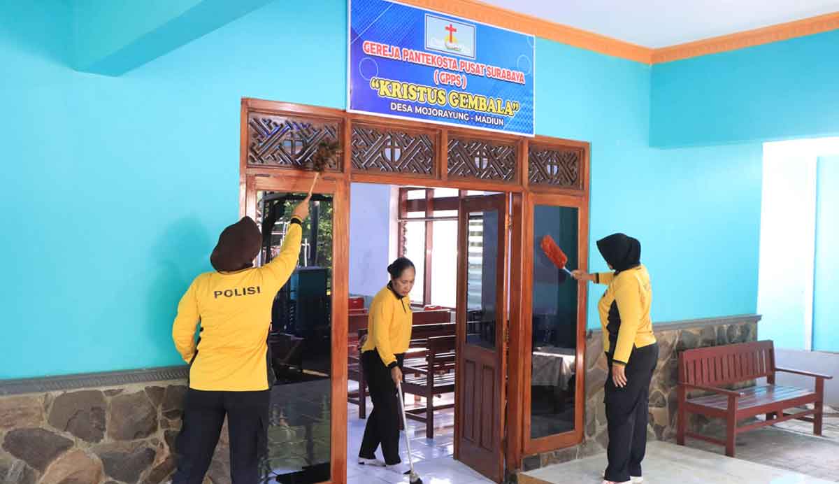Personel Polres Madiun saat membersihkan gereja.