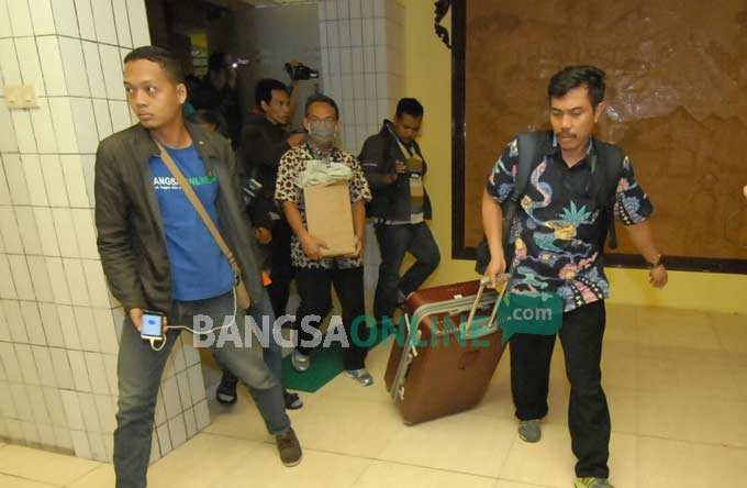 Petugas KPK membawa koper besar saat keluar dari ruang kerja Sekda Jombang, Ita Triwibawati, Senin (5/11). foto: RONY S/ BANGSAONLINE
