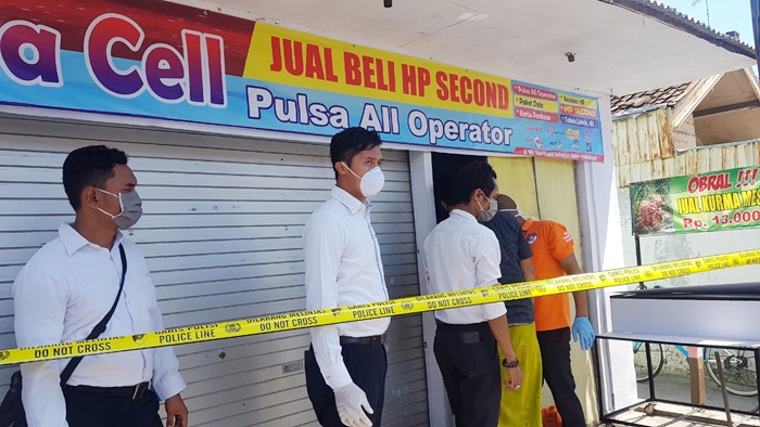 Petugas melakukan olah TKP dengan memasang police line di lokasi kejadian. 