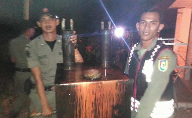 Petugas saat mengamankan tungku untuk mengolah arak. foto: SUWANDI/ BANGSAONLINE