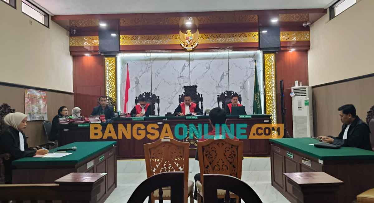Terdakwa pembunuhan satu keluarga di Dusun Gondanglegi, Desa Pandantoyo, Kecamatan Ngancar, Kabupaten Kediri, saat mengikuti sidang. Foto: MUJI HARJITA/BANGSAONLINE