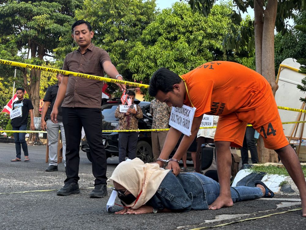 Salah satu adegan yang diperagakan oleh tersangka dalam rekonstruksi pembunuhan di Kecamatan Singgahan, Tuban. Foto: Suwandi/BANGSAONLINE