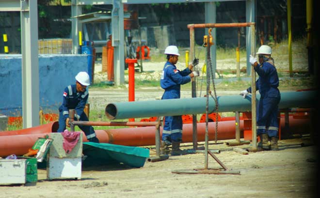 Para pekerja sedang memasang alat untuk pembersihan tapak sumur di Pad B, JOB PPEJ, Bojonegoro.