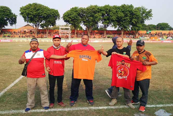 Korlap Persekabpas Pasuruan Hendry Sulfianto dan Korlap Deltas Sidoarjo Yoyok saat bertukar tali asih baju persaudaraan kedua belah pihak di Stadion R. Sudarsono Pogar Bangil, Minggu (26/8/2018). Foto: ANDY F/BANGSAONLINE