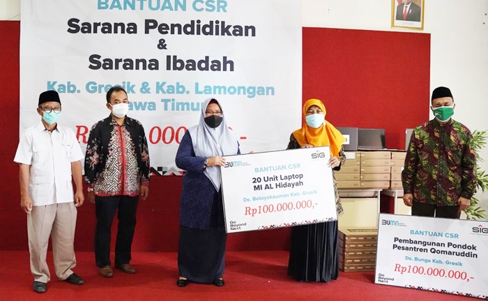 GM of CSR SIG Edy Saraya (dua dari kiri), dan Wabup Bu Min saat menyerahkan bantuan di SMK Qomarudin. foto: SYUHUD/ BANGSAONLINE