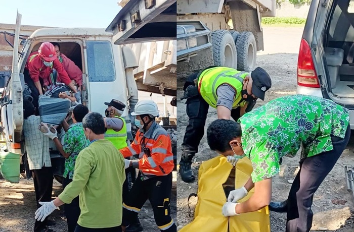 Jenazah korban saat dievakuasi petugas dari dalam kabin truk.