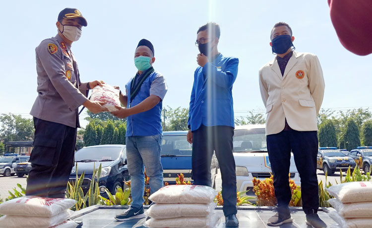 Kapolres Pasuruan AKBP Rofiq Ripto Himawan menyalurkan paket sembako kepada perwakilan dari HMI, PMII, dan Pemuda muhamadiyah untuk didistribusikan kepada mahasiswa dari Papua.