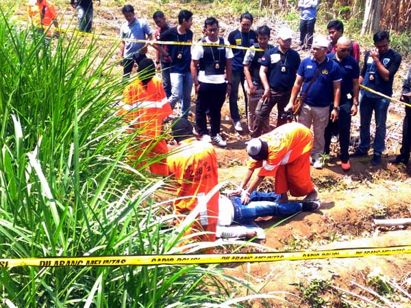 3 dari 6 tersangka saat melakukan adegan rekonstruksi di lokasi kejadian pembunuhan, samping sungai Rolak, Selasa (5/9). foto: IWAN IRAWAN/ BANGSAONLINE