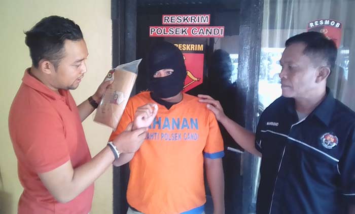 Pelaku gendut diapit petugas Polsek Candi Sidoarjo.