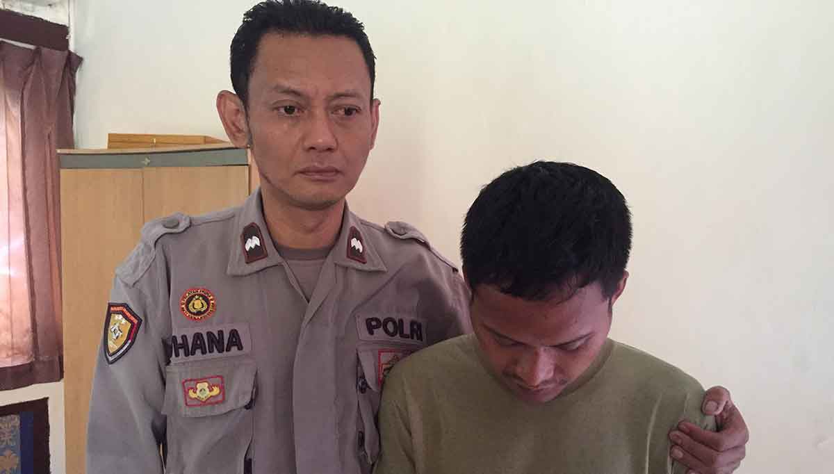 Petugas dari Polsek Wonocolo saat bersama pelaku pencurian laptop.