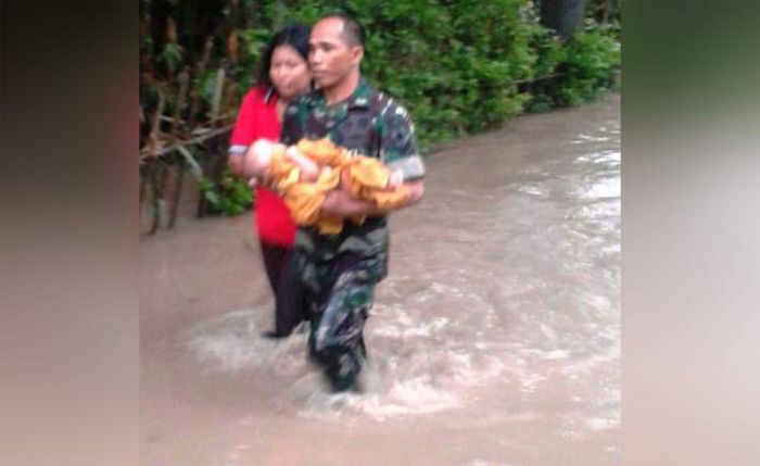 Babinsa Saradan Sertu Juhartono Selamatkan Bayi 6 Bulan Korban Banjir di Madiun