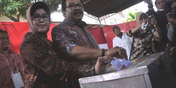 Gubernur Jatim Soekarwo dan isterinya Nina Kirana memasukkan kertas suara Pilpres di kotak suara TPS 27 Kelurahan Manyar Sabrangan Kecamatan Mulyorejo, Surabaya. foto :  nisa/BangsaOnline
 