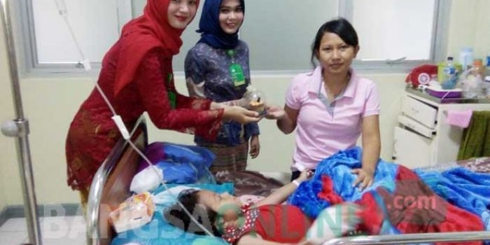 Pegawai RSNU Tuban saat memberikan cokelat ke salah satu pasien. foto: SUWANDI/ BANGSAONLINE