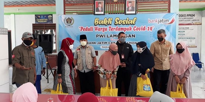 PWI Lamongan bersama Bank Jatim melakukan aksi bakti sosial berupa pemberian sembako untuk warga terdampak Covid-19 di Balai Desa Kembangbahu, Kecamatan Kembangbahu, Lamongan, Rabu (28/7/2021). (foto: ist)