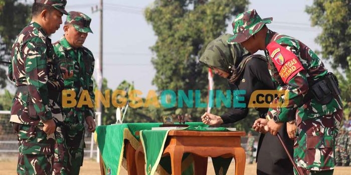 Bupati Mojokerto, Ikfina Fahmawati, dan Dandim 0815/Mojokerto, Letkol Inf Rully Noriza, ketika menandatangani prasasti TMMD 121 yang disaksikan Danrem 082 CPYJ. Foto: NINA PUJI RAHAYU/BANGSAONLINE