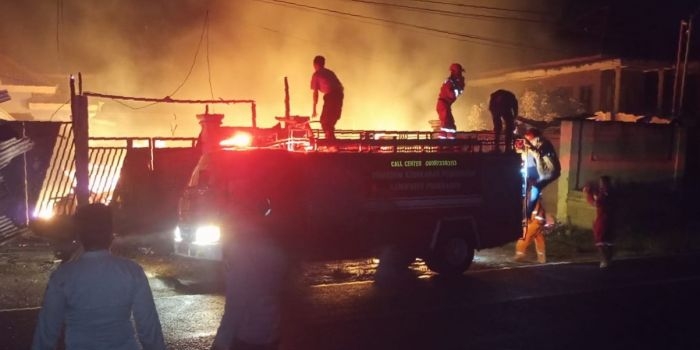 Mobil damkar beserta petugas yang tiba di TKP kebakaran saat melakukan pemadaman api